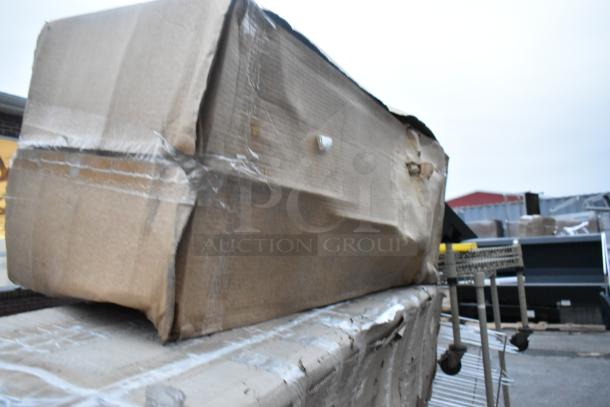 Cardboard box containing 4 new Regency stainless steel items with scratch and dent, taped and slightly damaged.