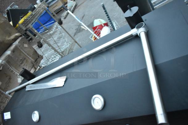 Backyard Pro black metal portable grill with commercial casters, featuring dual thermometers and sturdy handles.