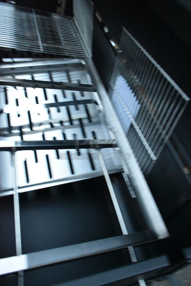 Backyard Pro black metal portable grill, features durable grates and commercial casters, excellent condition.