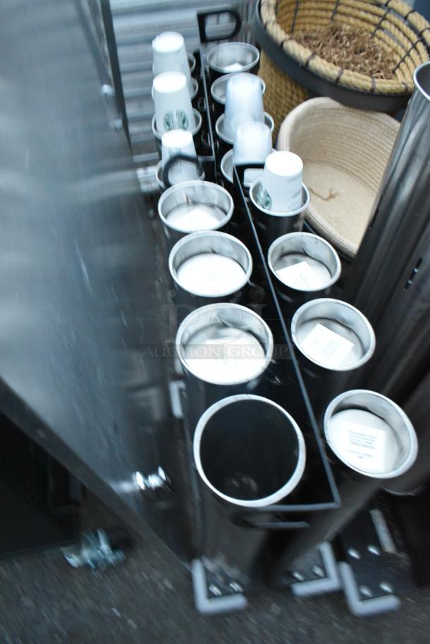 Three metal cup dispensers, two with 8 chutes and one with 3 chutes, on commercial casters. Suitable for bulk cup storage.