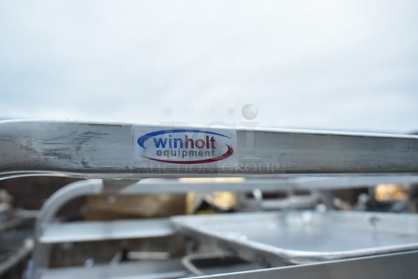 Metal portable pan rack on commercial casters with "Winholt Equipment" label visible, indicating brand.
