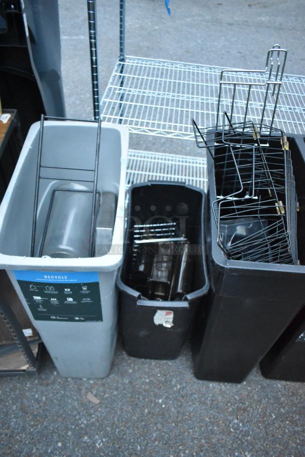 Various items including two black trash cans, a gray recycling bin with label, wire shelving unit, and metal racks.