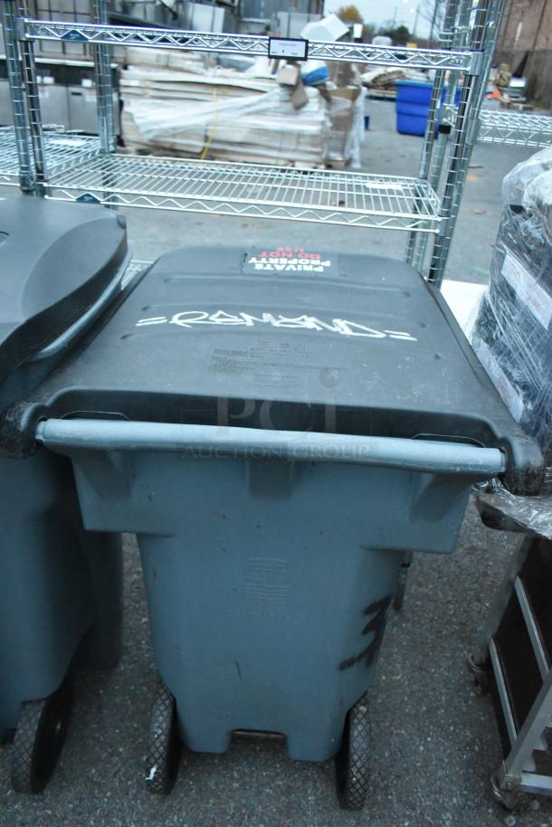 Two gray poly trash cans, marked and labeled "PRIVATE PROPERTY DO NOT USE," wheels visible, outdoor setting.