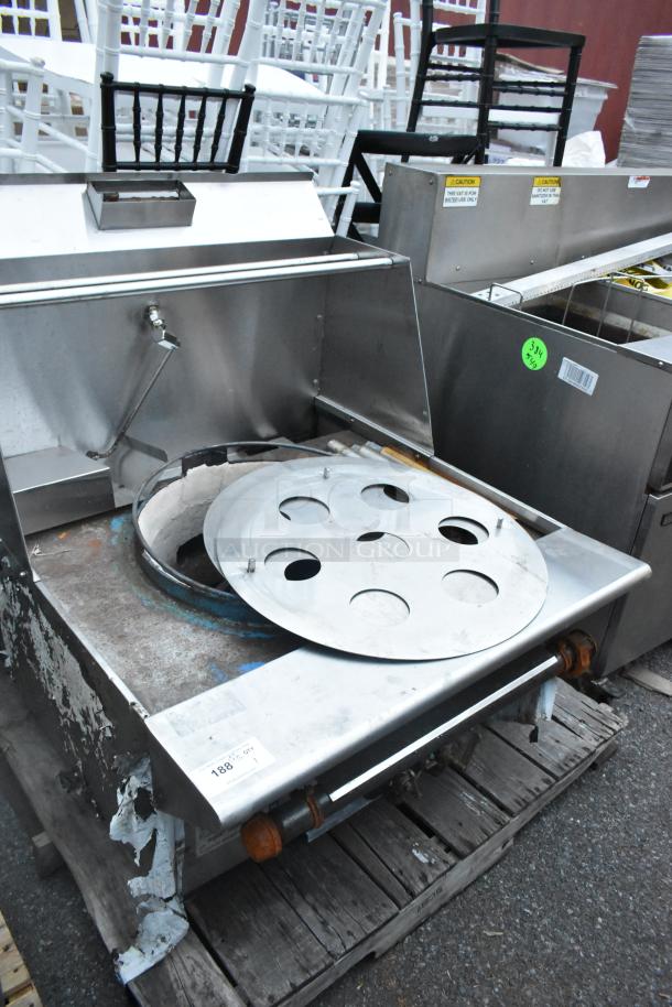 Stainless steel commercial gas-powered single burner wok range with round burner cover. Used condition with visible wear.