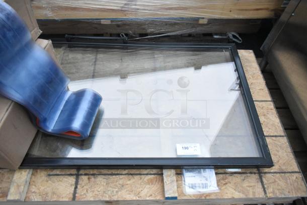 Two brand new scratch and dent doors stacked, with visible packaging. Item tag shows "190 qty."