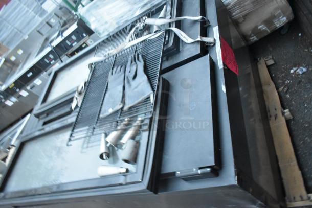 Metal Commercial 2 Door Reach In Cooler with black finish. Includes interior racks and gloves. Some wear visible.