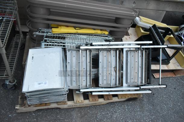 Three pallets with a ladder, mop bucket, metal baking pans, and storage trays. Mixed items for auction, good condition.