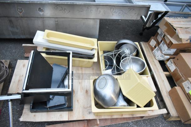 Three pallets filled with various items including a ladder, mop bucket, metal baking pans, and mixed containers. Items show mixed use.