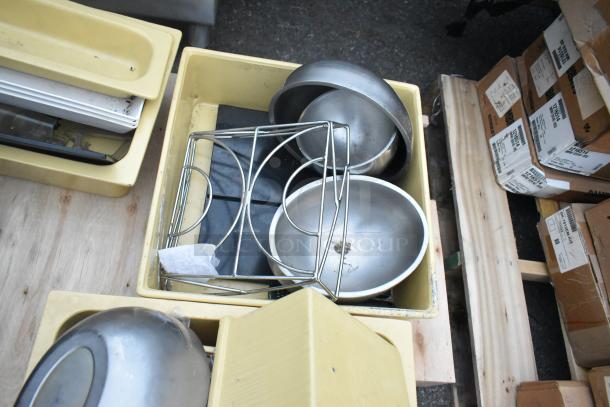 3 pallets containing various items like a ladder, mop bucket, and metal baking pans. Includes yellow bins and boxed items.