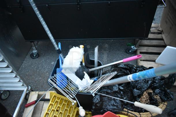 Three pallets with cleaning tools, a ladder, mop bucket, and metal baking pans, in used condition; various items shown.
