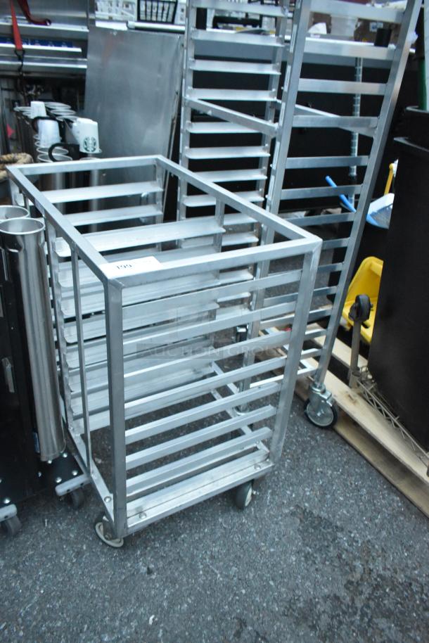 Metal commercial double pan transport rack on casters, featuring sturdy metal construction. Ideal for kitchen use.