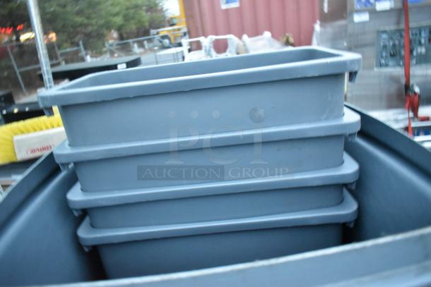 Four stacked gray poly trash cans in good condition, outdoor setting.