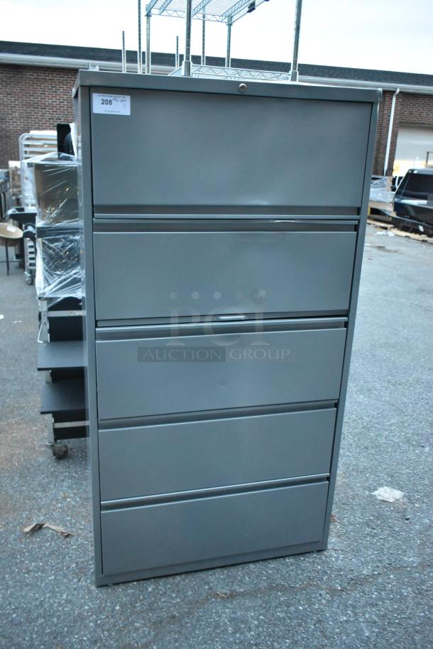Gray metal filing cabinet with four drawers and one door, in good condition. Tag reads "208".