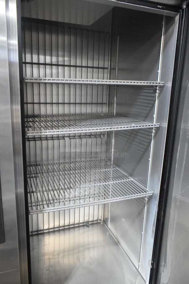 2020 True T-49F-HC stainless steel freezer, 2-door, interior showing poly-coated racks, on commercial casters, 115V.