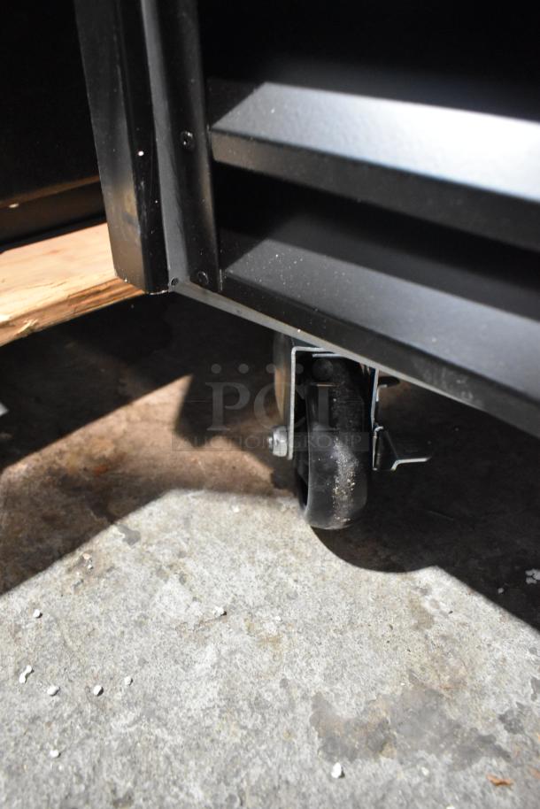 Avantco 178GDS47HCB merchandiser refrigerator, black metal, sliding glass door, visible caster wheel, new condition.