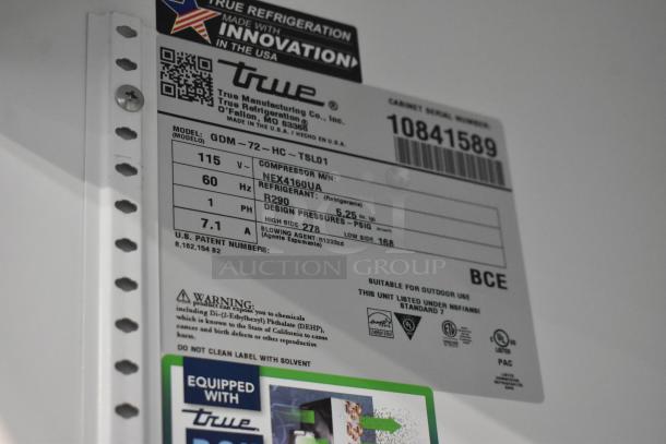 Label of True GDM-72-HC cooler merchandiser detailing model, voltage, refrigerant type, and safety warnings.