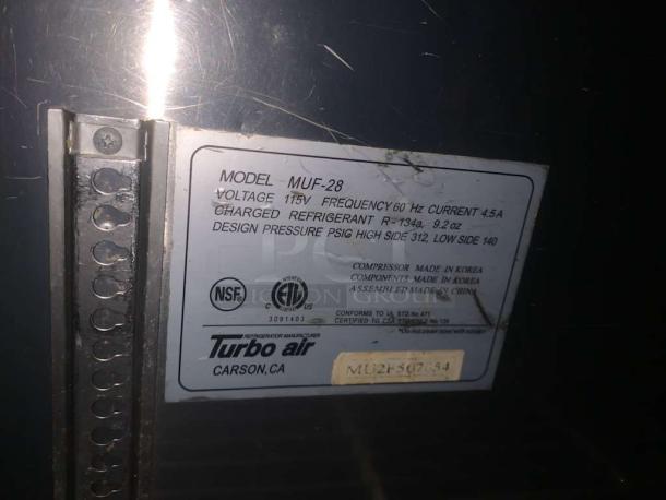 Turbo Air MUF-28 under-counter freezer label showing model, voltage 115V, NSF and ETL certifications, and refrigerant details.