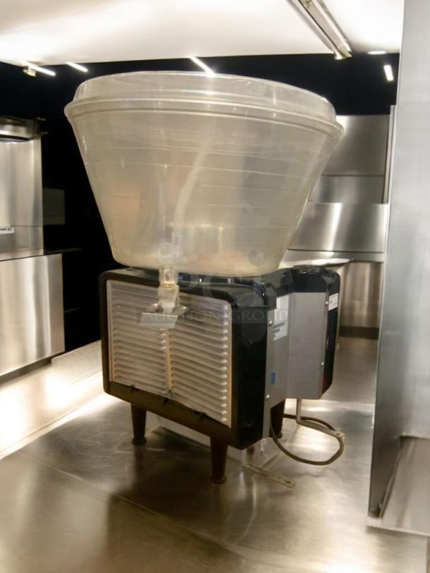 Prime condition frozen beverage granita dispenser, fully tested, transparent container, metal base, excellent working order.