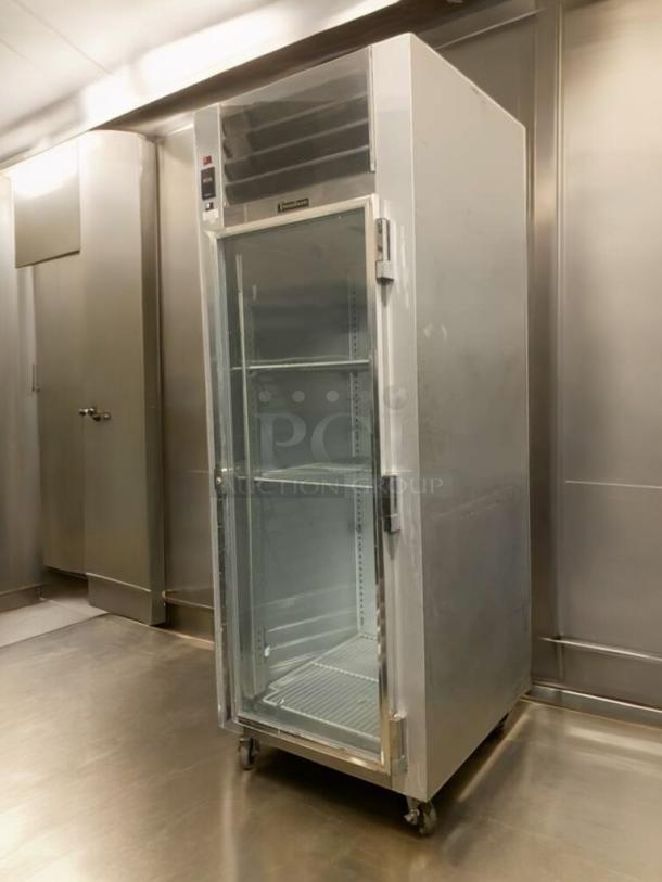 Traulsen G11010 glass door refrigerator, prime condition, 115V, fully tested, with adjustable shelves and visible brand logo.
