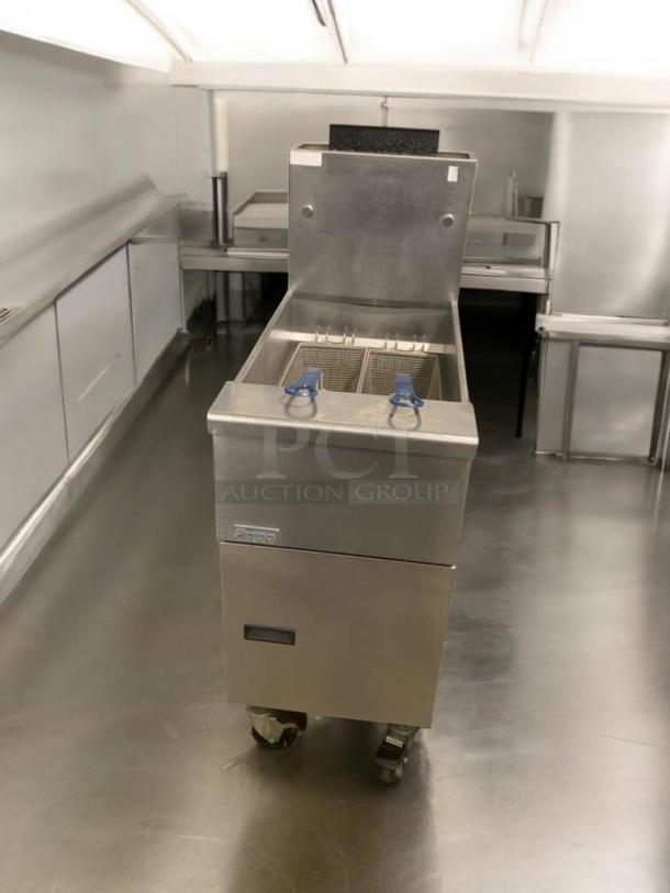 Pitco VF35 natural gas fryer, 70,000 BTU, excellent condition. Features twin fry baskets, steel construction, fully tested.