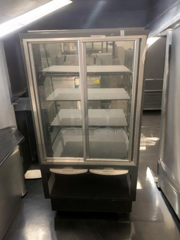 Commercial hot food display case in superior condition, glass doors, multiple shelves, fully tested and working.