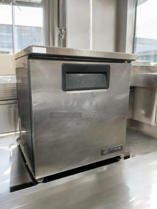 True TUC-27-LP undercounter refrigerator in superior condition, stainless steel, 115V, tested, with True Manufacturing logo.