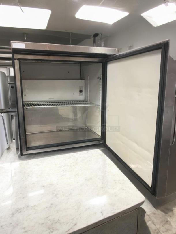 True TUC-27-LP undercounter refrigerator, stainless steel, open door showing interior, superior condition, 115V tested.
