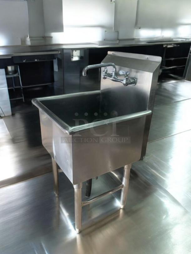 Single-basin stainless steel utility sink with faucet and drainboard, in immaculate condition, fully tested and working.