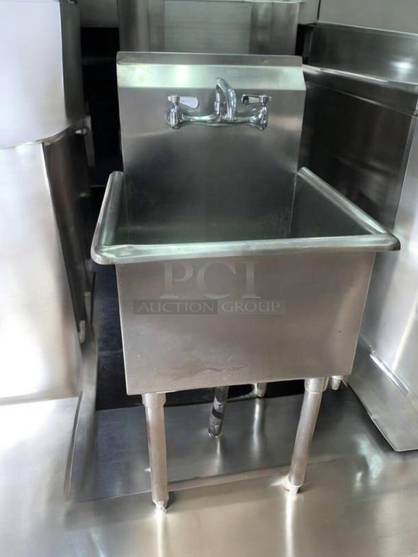 Single-basin stainless steel utility sink with faucet and drainboard, immaculate condition, fully tested and working.