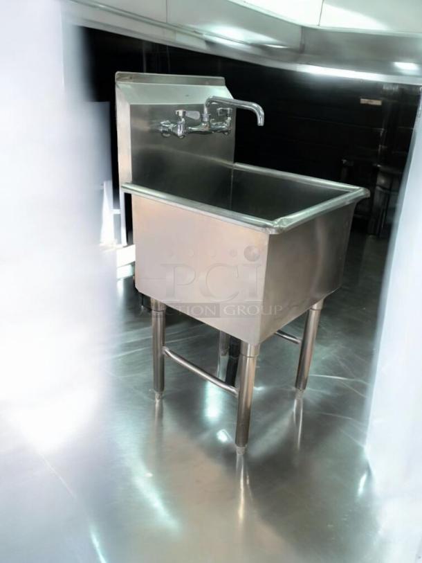 Single-basin stainless steel utility sink with faucet and drainboard; immaculate condition, fully tested and working.