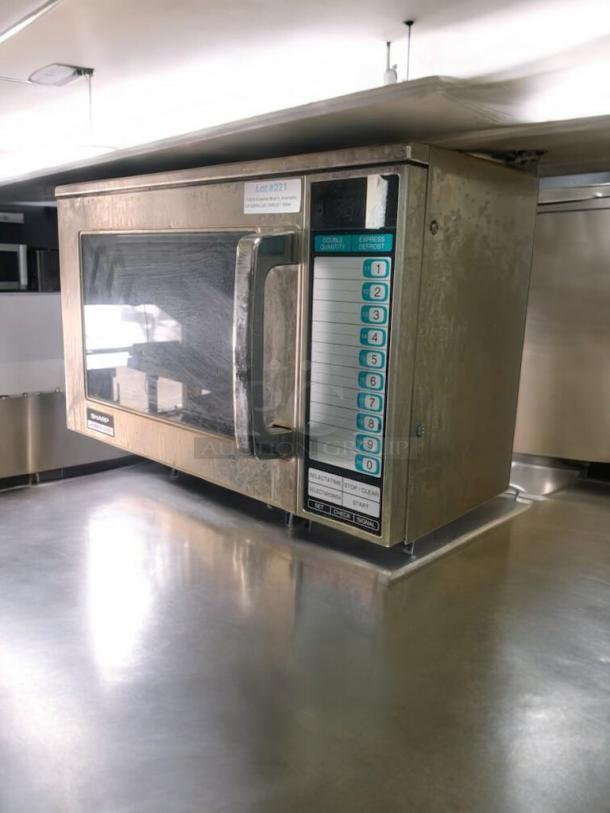 Sharp commercial microwave, heavy-duty model, fully operational, prime condition, visible control panel and door handle.