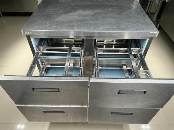Delfield D4448NP undercounter refrigerator with flat top, 4 drawers open, stainless steel, tested and working condition.