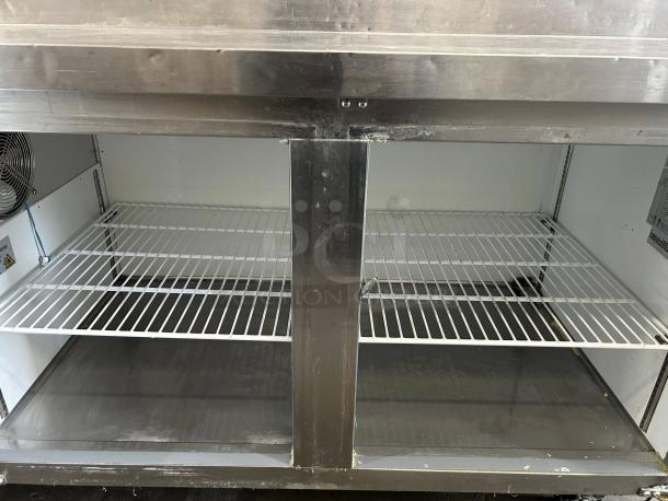 Kintera KRR70X two-door pizza prep refrigerator in great condition, fully tested and working, showing interior shelves.
