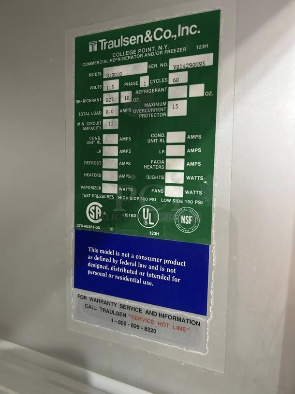 Traulsen G10010 refrigerator label showing model, serial number, voltage, refrigerant details, and compliance logos.