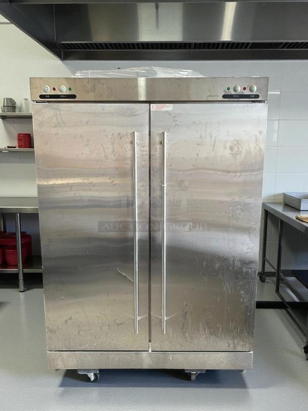 Stainless steel 2-door refrigerator, model XDR640-F1A, in excellent condition, tested and working, with castor wheels.