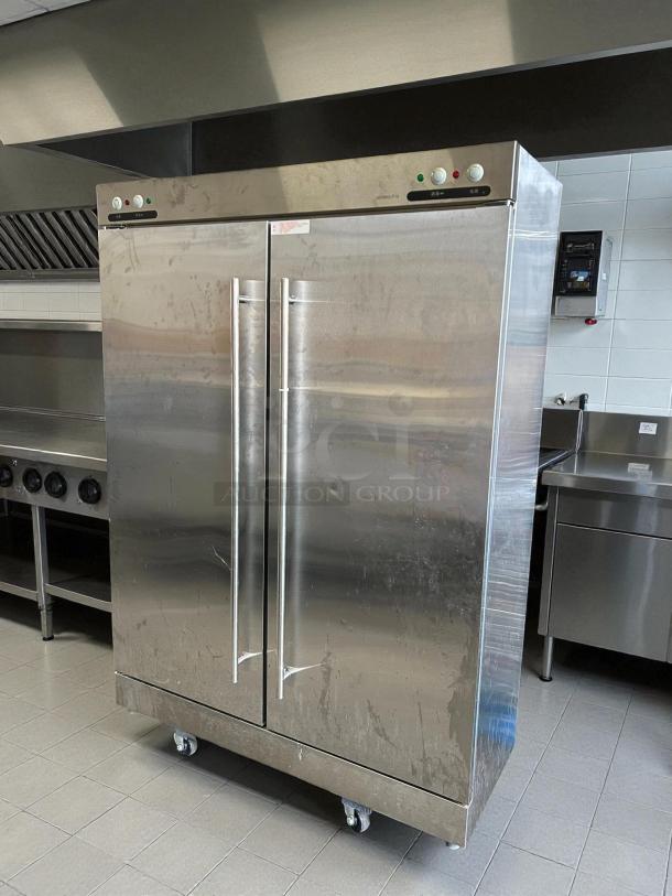 Two-door stainless steel refrigerator, model XDR640-F1A, excellent condition, tested and working, on wheels.