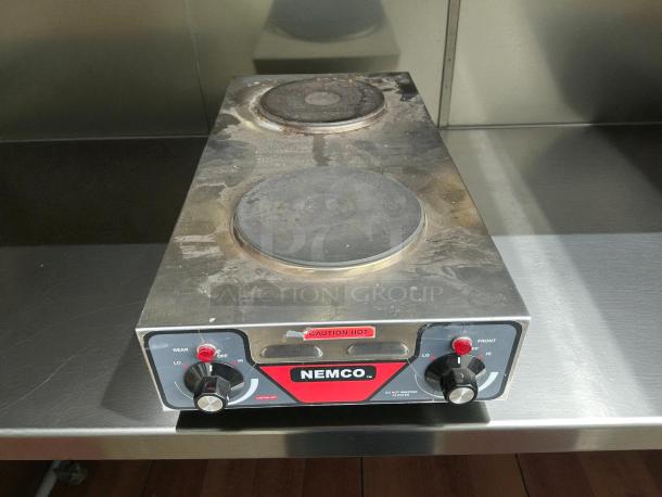 Nemco 6310-2-240 cast iron burner with two 1.5kW elements, in excellent condition. Features control knobs and caution labels.