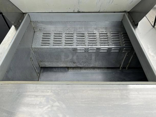 Continental SW60N24M 60" 2-door mega top refrigerated sandwich prep table. Interior view, metal surface, tested, working condition.