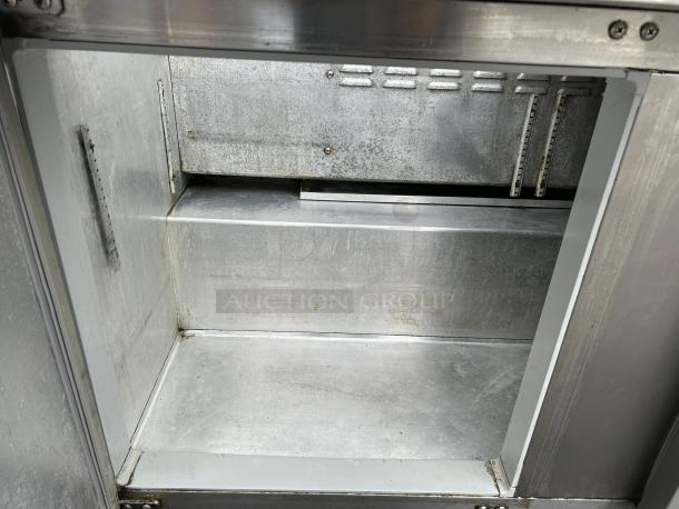 Continental SW60N24M 60" 2-door mega top refrigerated prep table interior, stainless steel, showing shelves and clean surfaces.