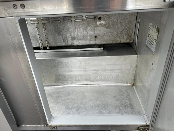 Continental SW60N24M 60" 2-door refrigerated prep table interior. Stainless steel, adjustable shelves, tested and working.