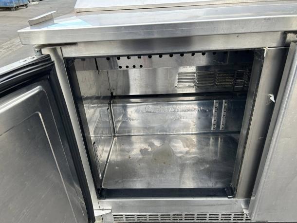 Everest EPBNR3 71" stainless steel refrigerated prep table, features 3 solid doors, interior shown clean and tested working.
