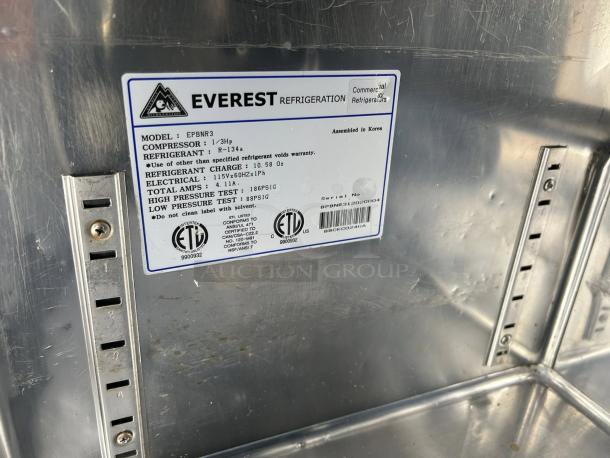 Everest EPBNR3 71" stainless steel refrigerated sandwich prep table. Features 3 solid doors, tested and working. Label shows model, refrigerant info.