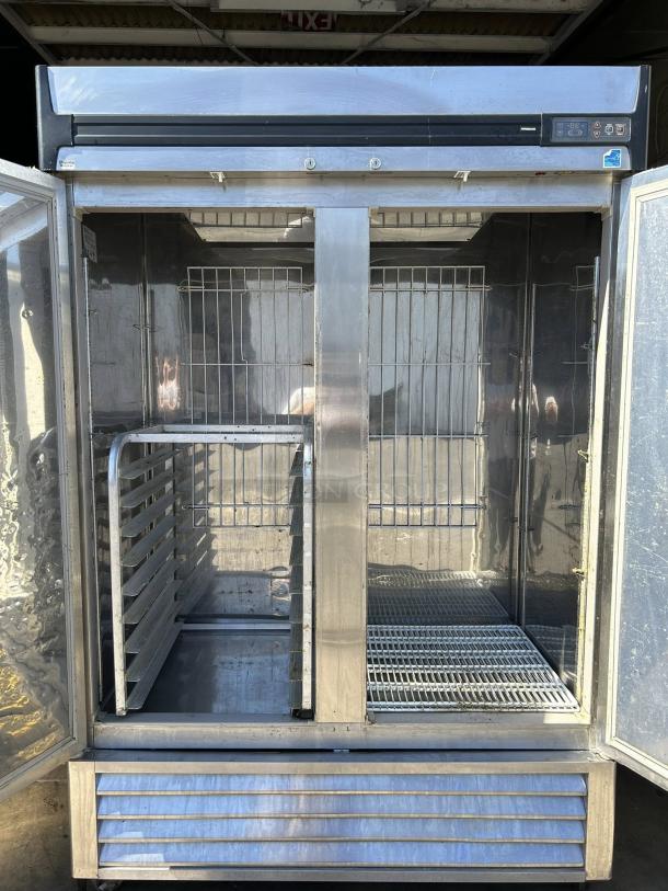 Superior R49-S 2-Door Reach-In Refrigerator in excellent condition, stainless steel, tested and working, open doors show shelving.