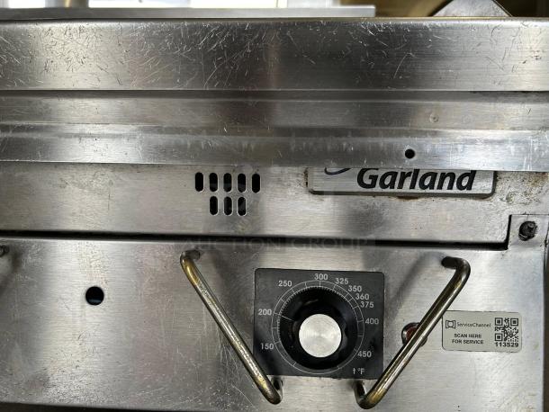 Garland UTGG60-GT60M gas griddle in excellent condition, tested and working. Features temperature dial and brand label.