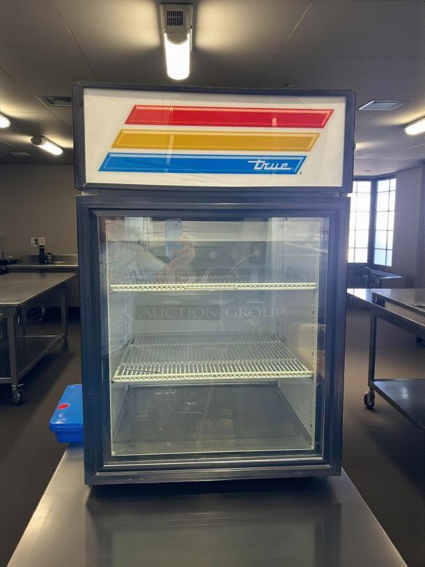 True GDM-05-HC~TSL01 black glass door countertop merchandiser, excellent condition, tested and working, dual shelves.