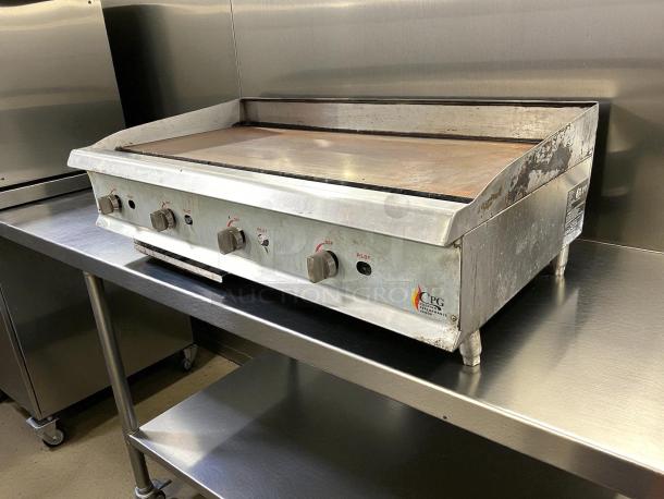 Cooking Performance Group GM-CPG-48-NL gas griddle, 48", manual controls, great condition, tested, on stainless steel countertop.
