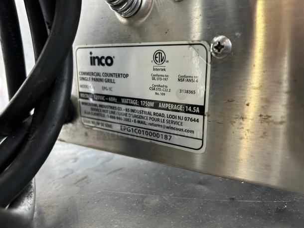 Winco EPG-1C commercial panini press label close-up, showing model, voltage, wattage, and contact information.