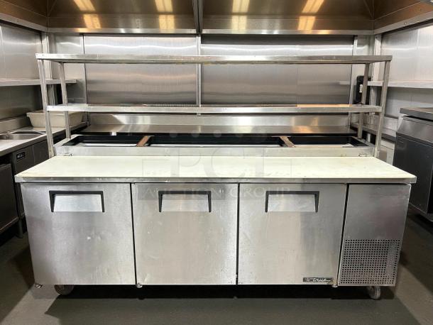 True TPP-93 93" 3-door refrigerated pizza prep table with overshelf, stainless steel, tested and working condition.