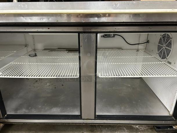 True TPP-93 93" refrigerated pizza prep table with three doors and overshelf. Tested, working condition, some wear visible.