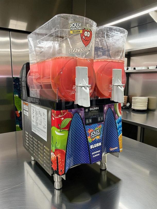 Bunn 58000.0015 ULTRA NX frozen drink machine in black and stainless steel; excellent condition; 120V; Jolly Rancher Slush branding.